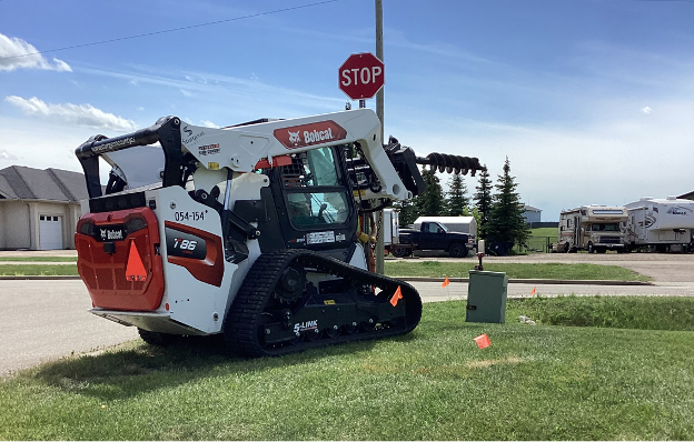 Photo showing the installation of a stop sign.